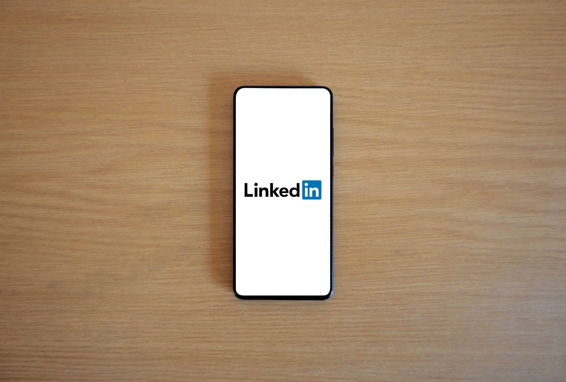 Laptop screen showing a LinkedIn profile page with messaging interface open