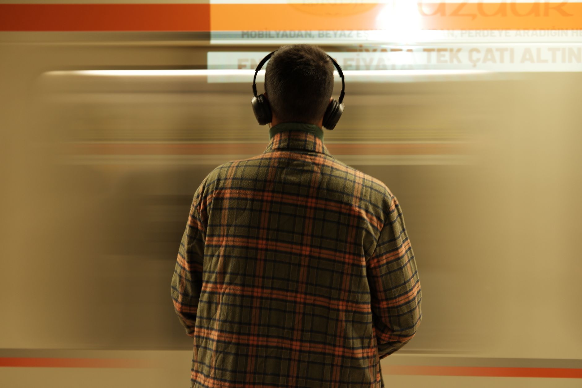 Person wearing headphones and listening to audio content