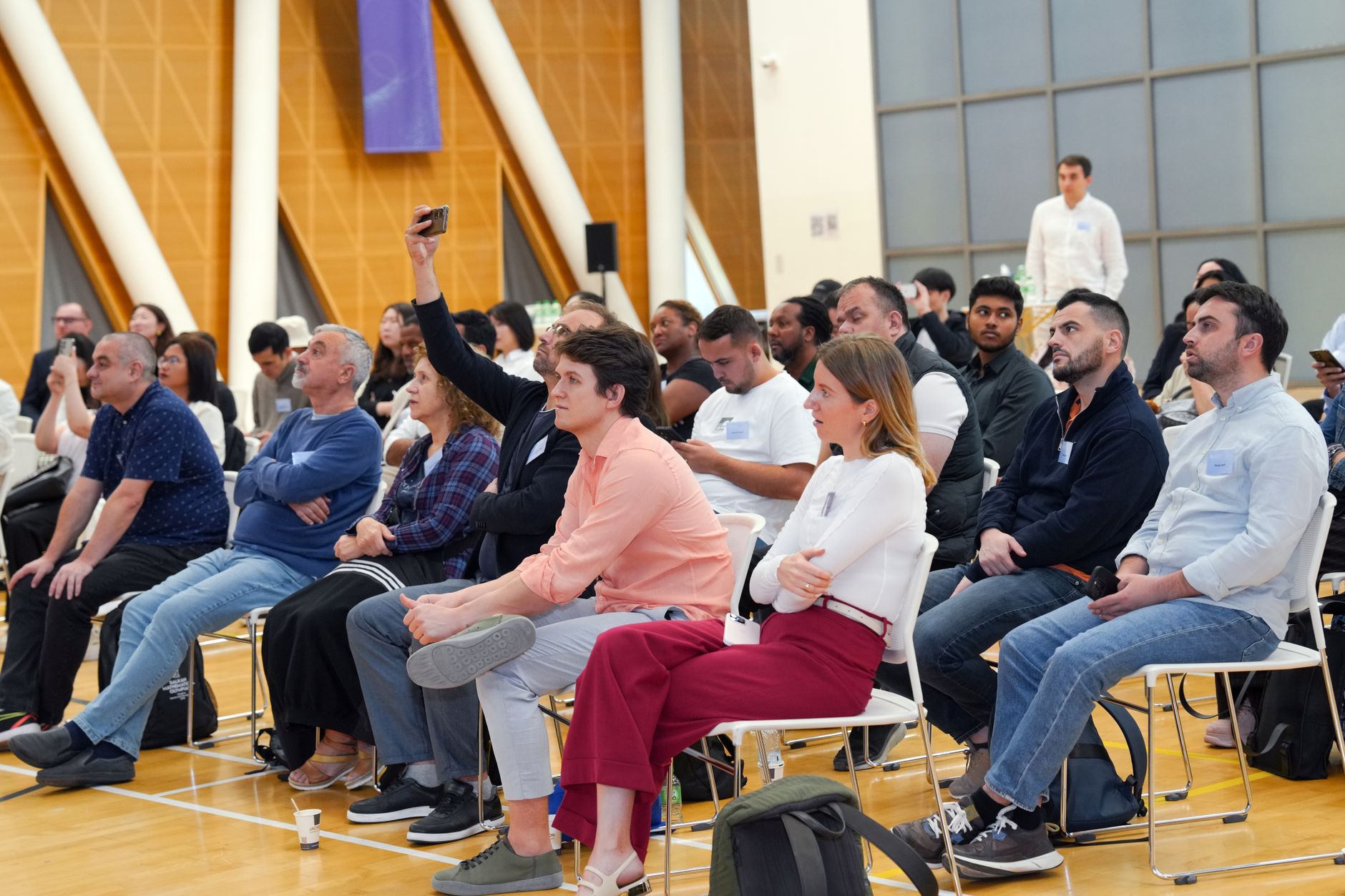 Audience member asking a question at a public event, representing the open Q&A format of Reddit AMAs