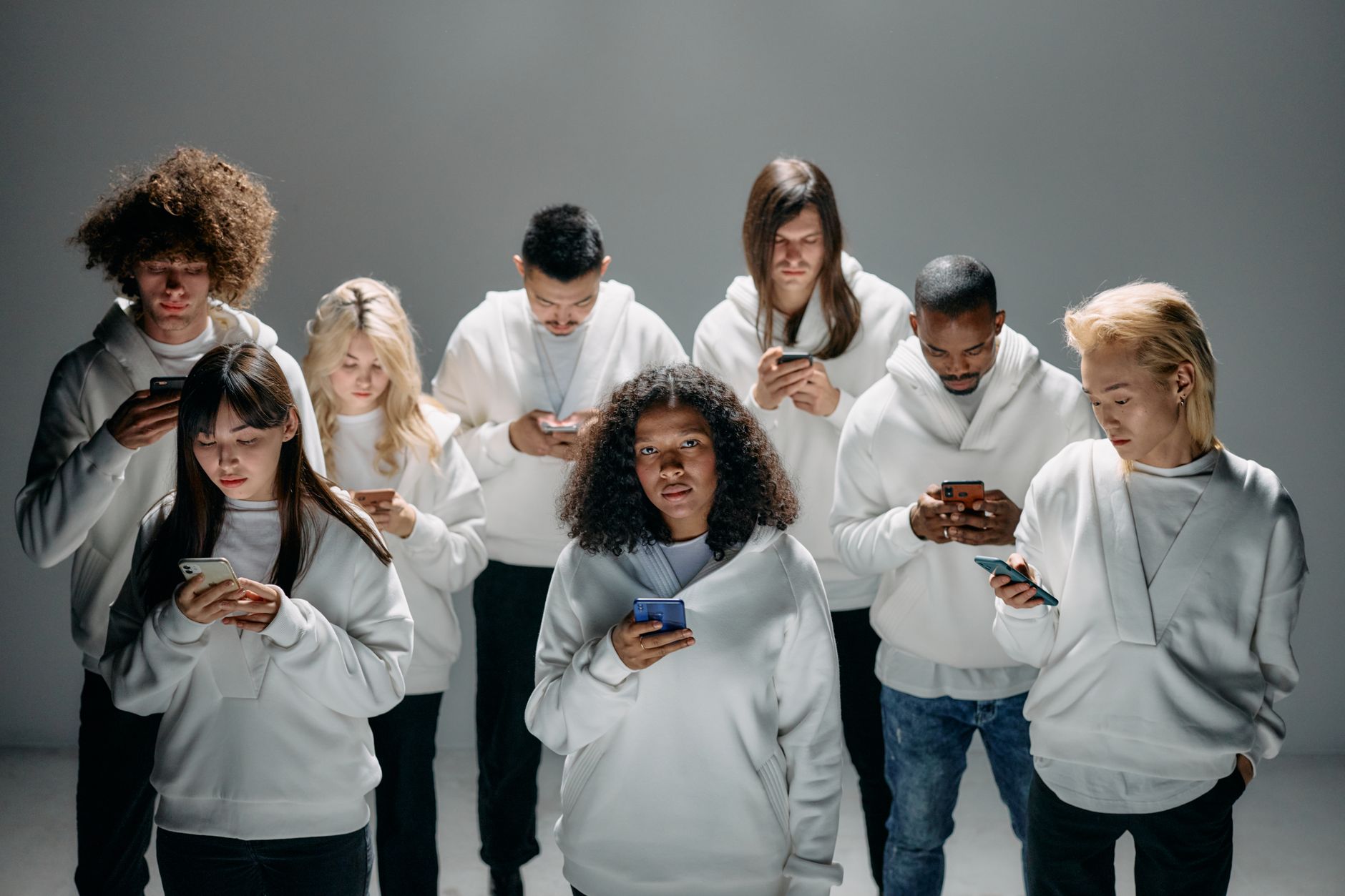 Diverse group of people engaging with content on laptops and phones