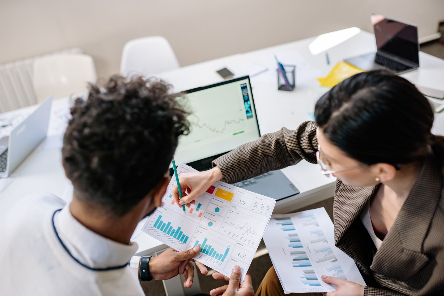 Two professionals reviewing content strategy documents at a table