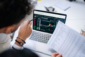 Person reviewing a spreadsheet on a laptop, representing manual lead prospecting workflows