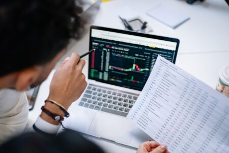 Person reviewing a spreadsheet on a laptop, representing manual lead prospecting workflows