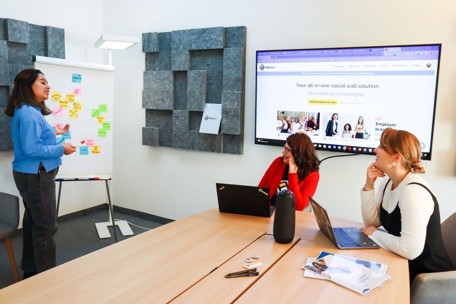 A designer working on a presentation layout on a computer screen in a modern office