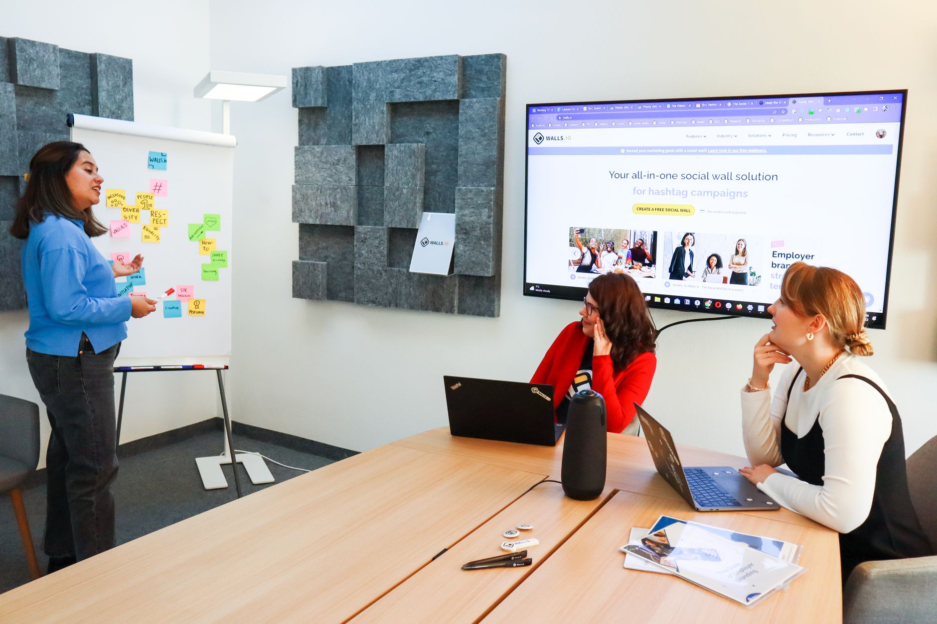 A designer working on a presentation layout on a computer screen in a modern office