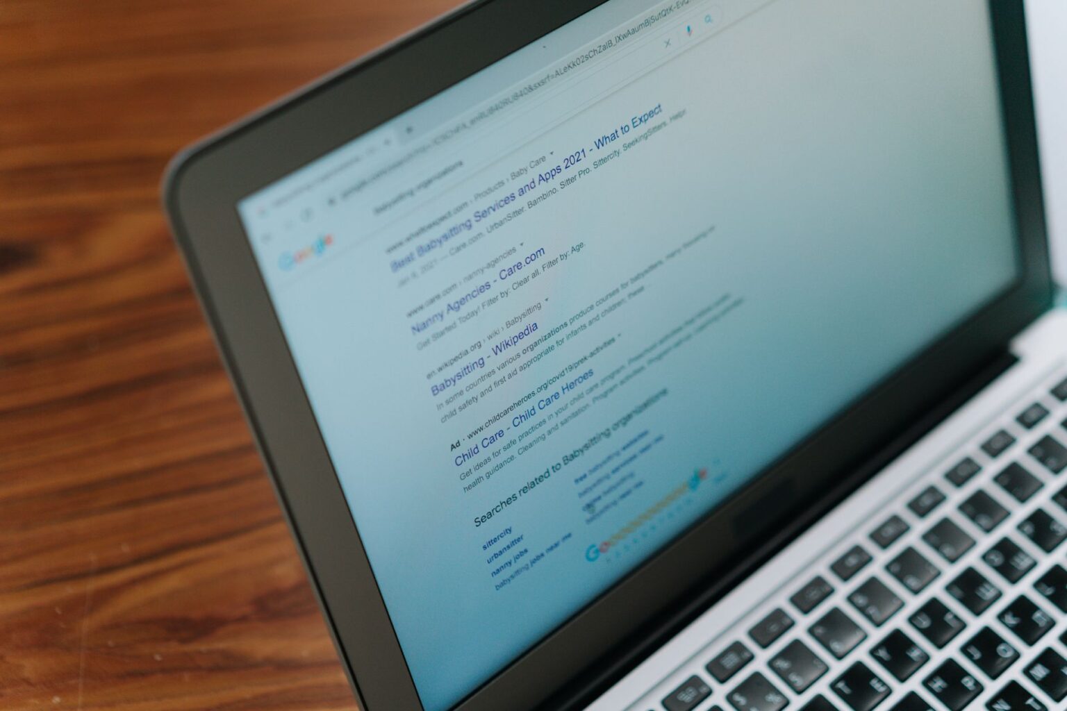 Person viewing search results on a laptop screen during brand research
