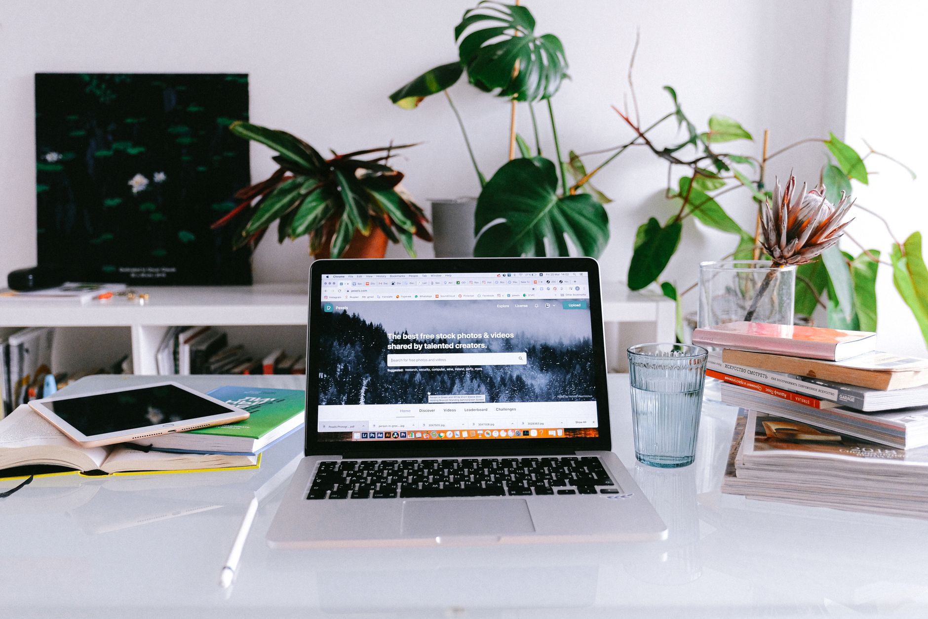 Freelancer working at a home desk with multiple screens showing social media dashboards