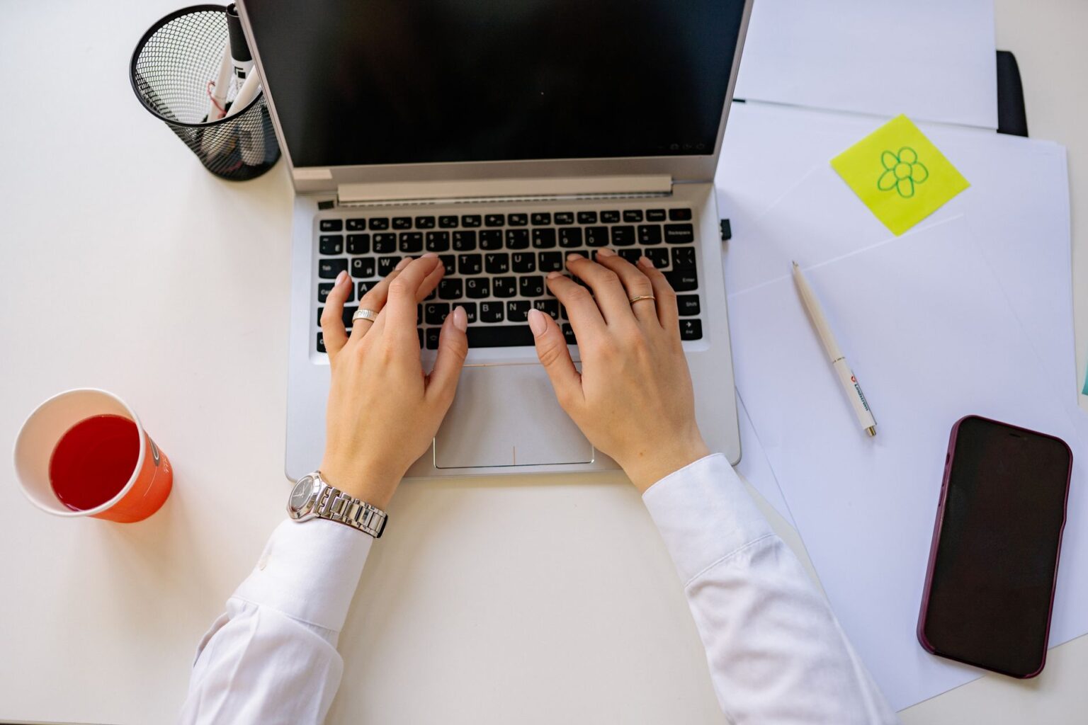 A person working at a computer desk setting up digital workflow automations
