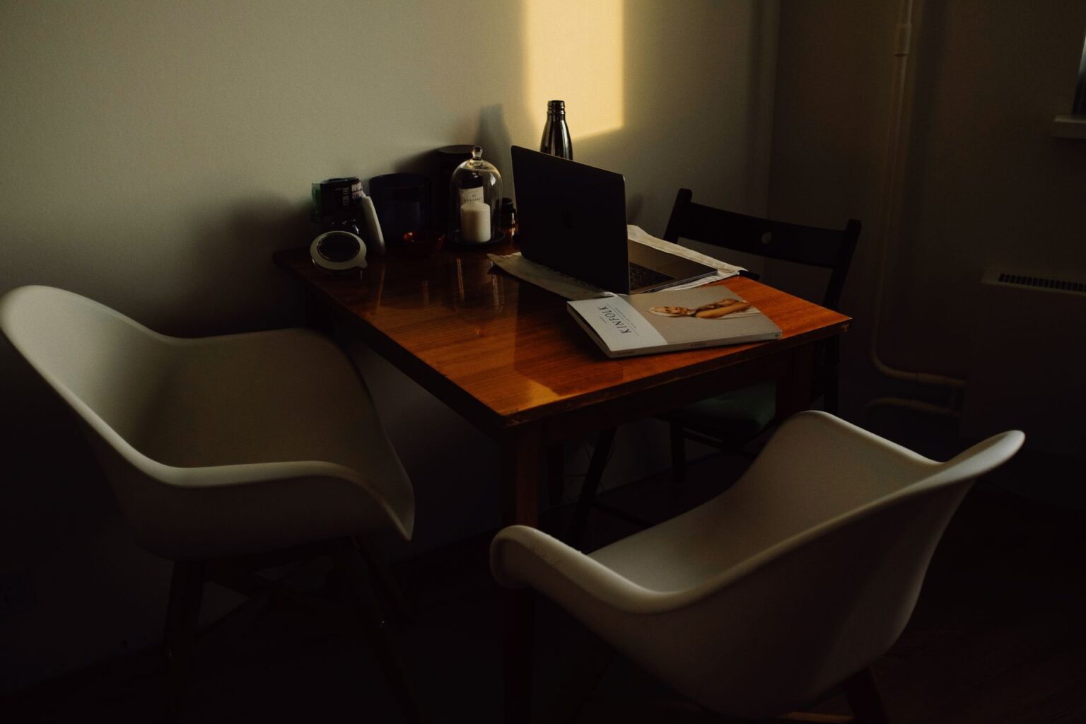 A marketing professional working on ad creatives at a laptop in a modern design workspace