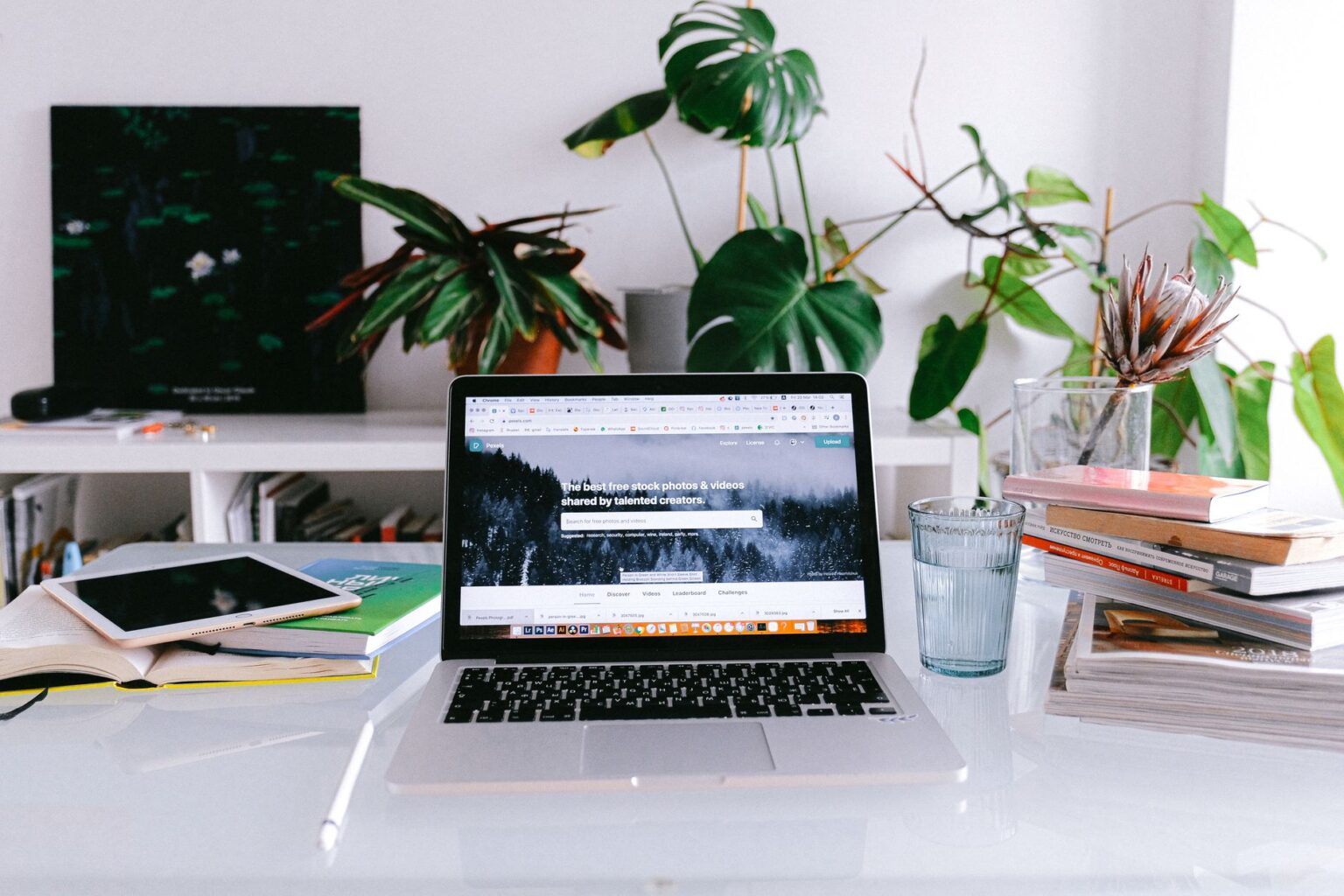 Freelancer working on a laptop in a home office, managing multiple browser tabs