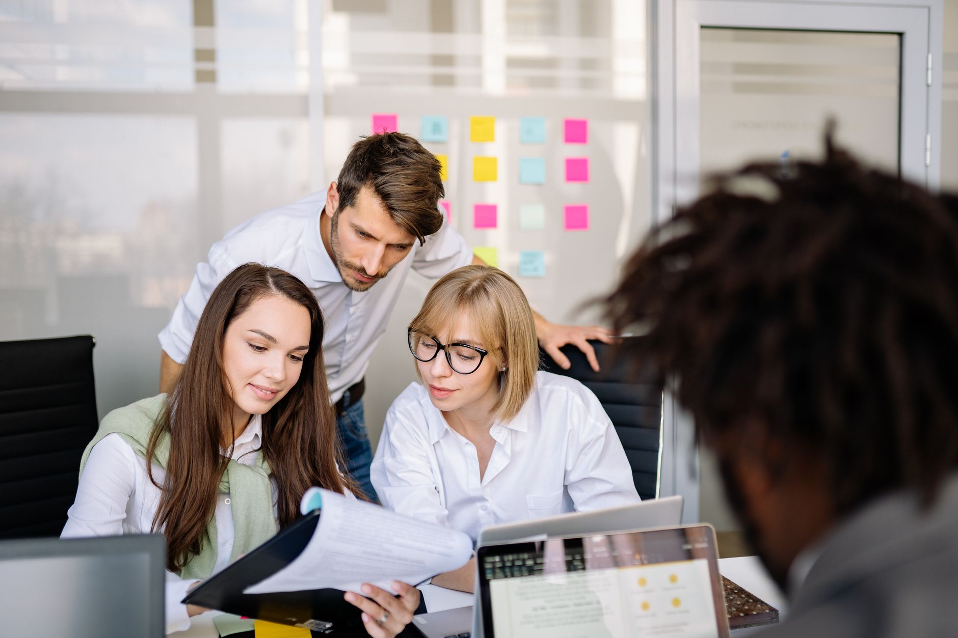 A small creative team reviewing visual content on a shared monitor