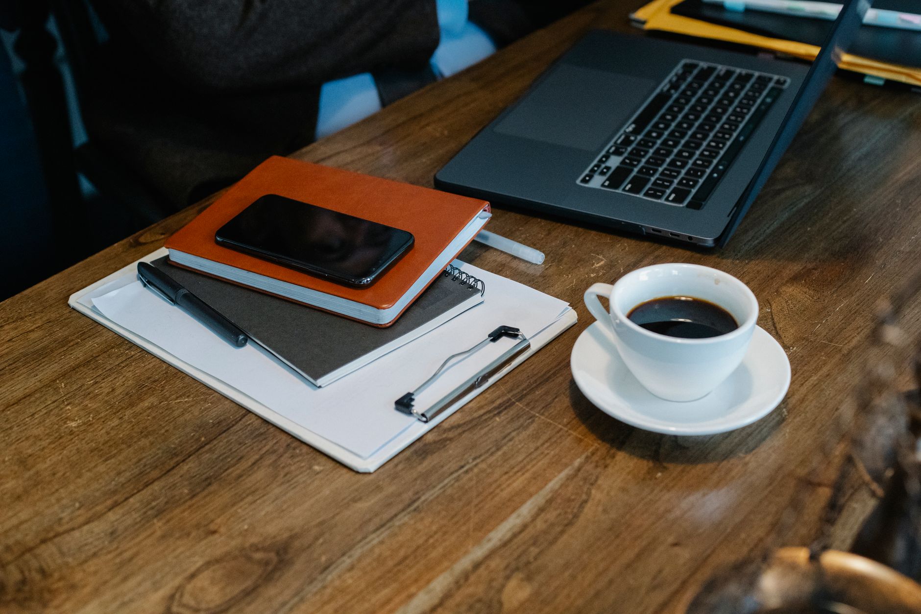 Content creator working at a clean desk setup with multiple screens open