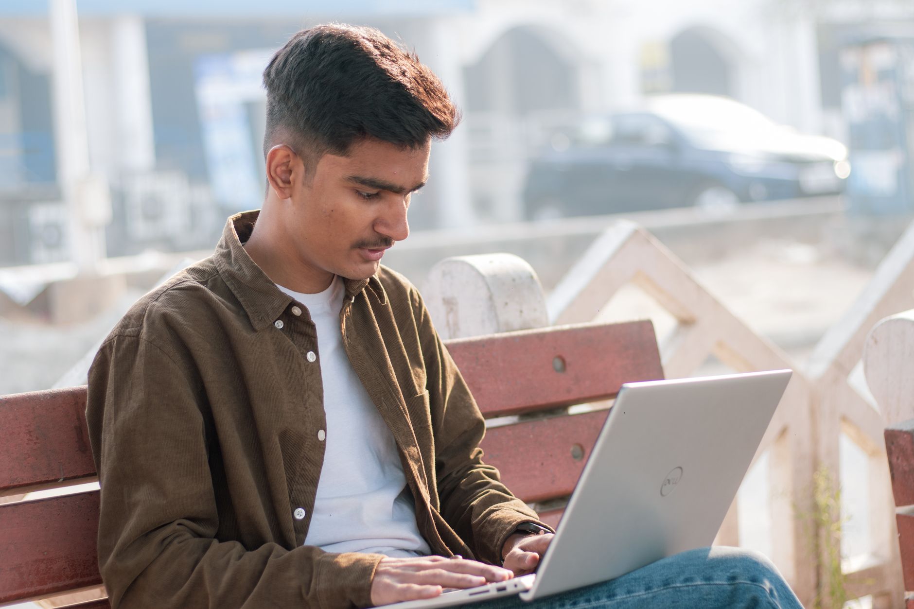 A person typing social media content on a laptop at a desk