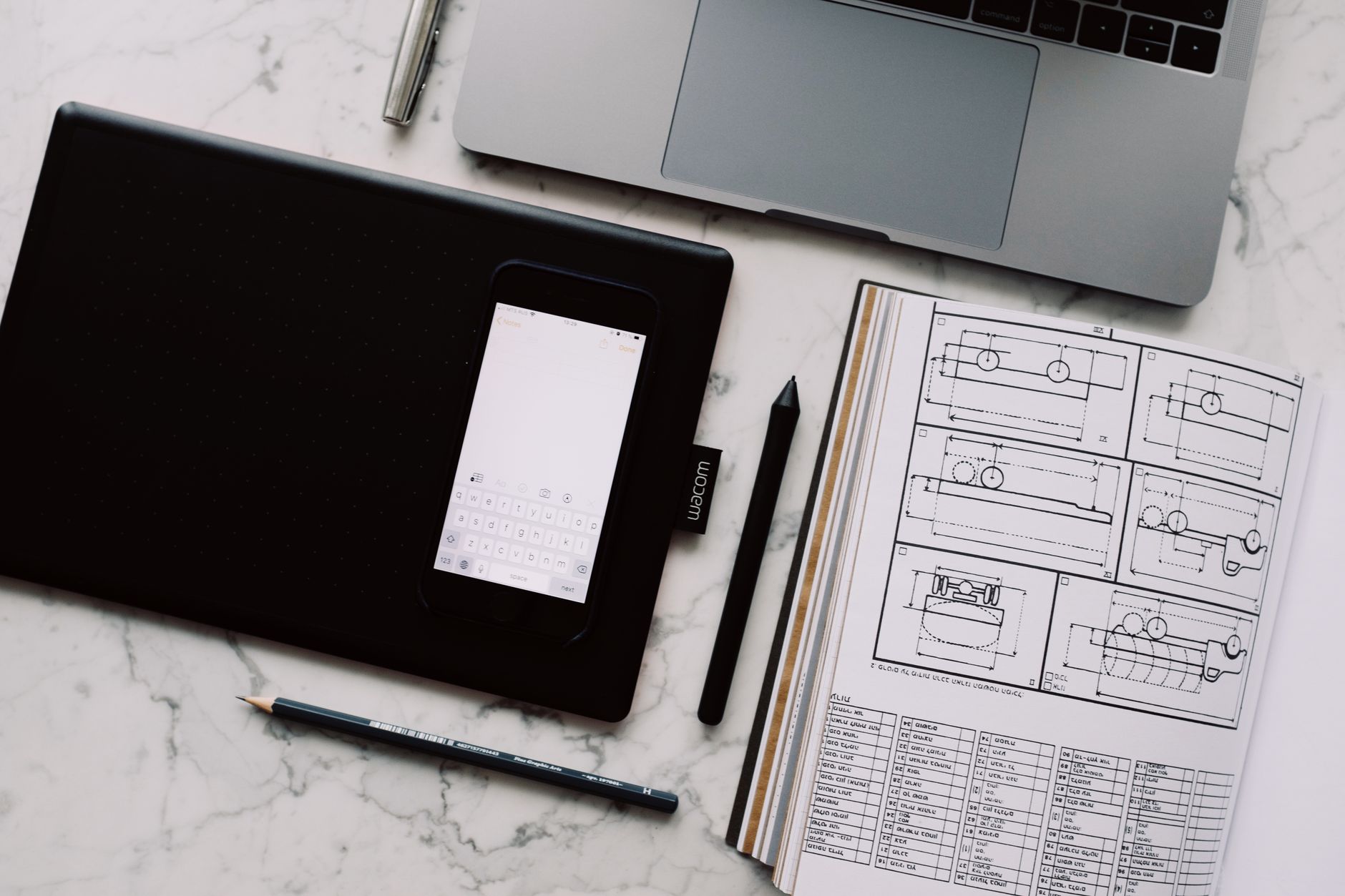 A content creator working on graphic design at a modern laptop workspace