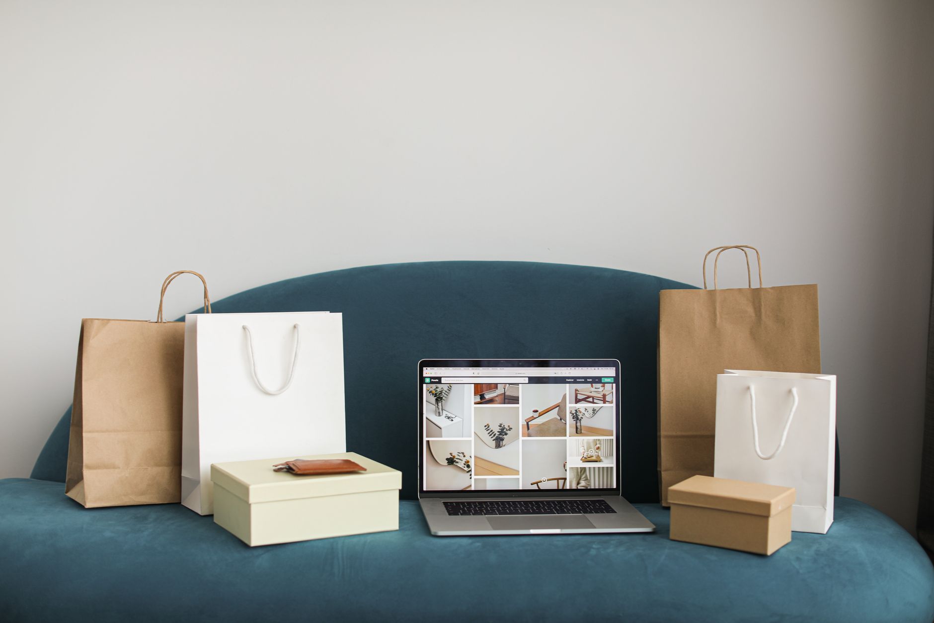 Laptop displaying a minimal online storefront interface with product listings