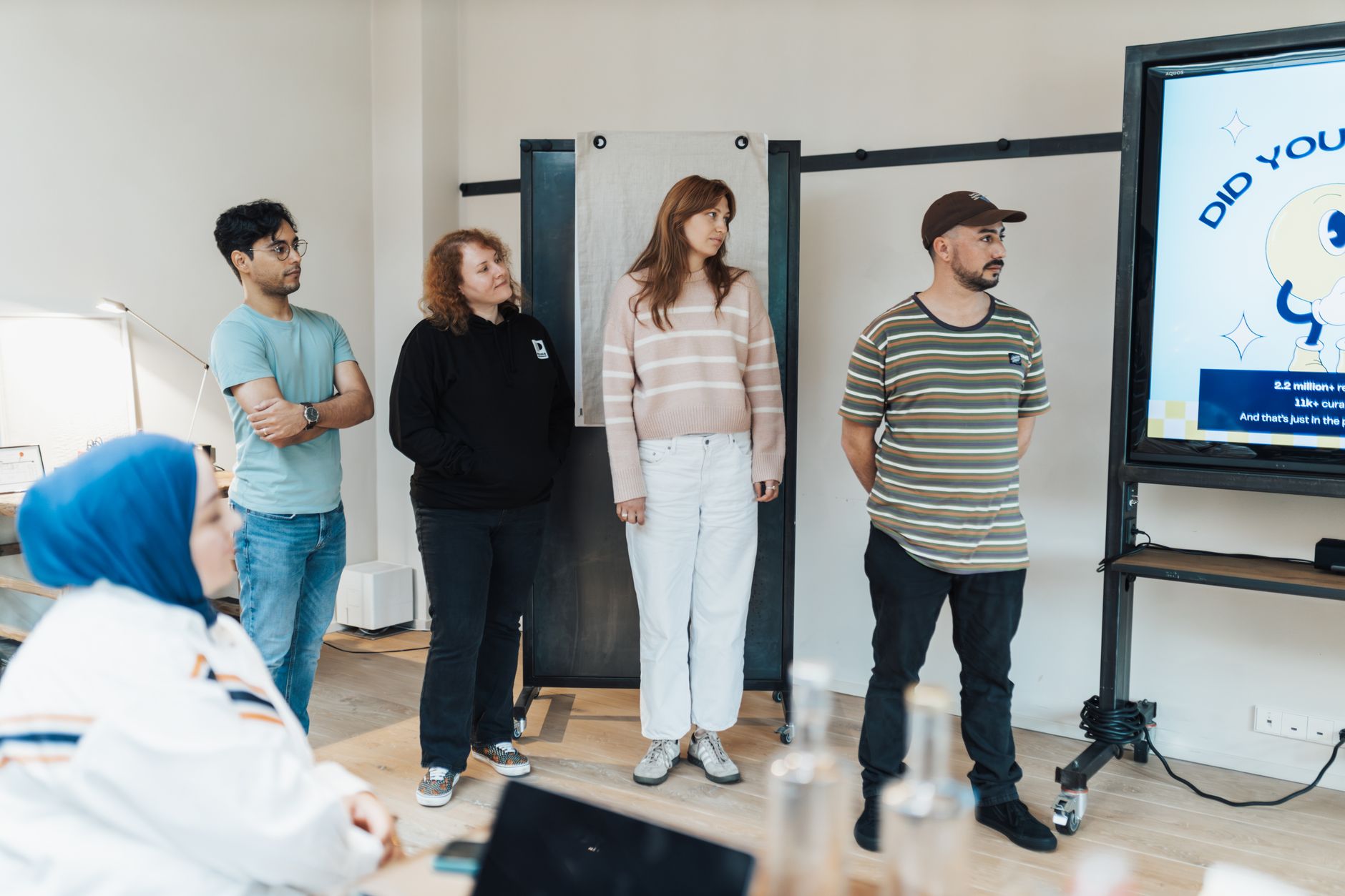 Marketing team reviewing social media content strategy on a computer screen