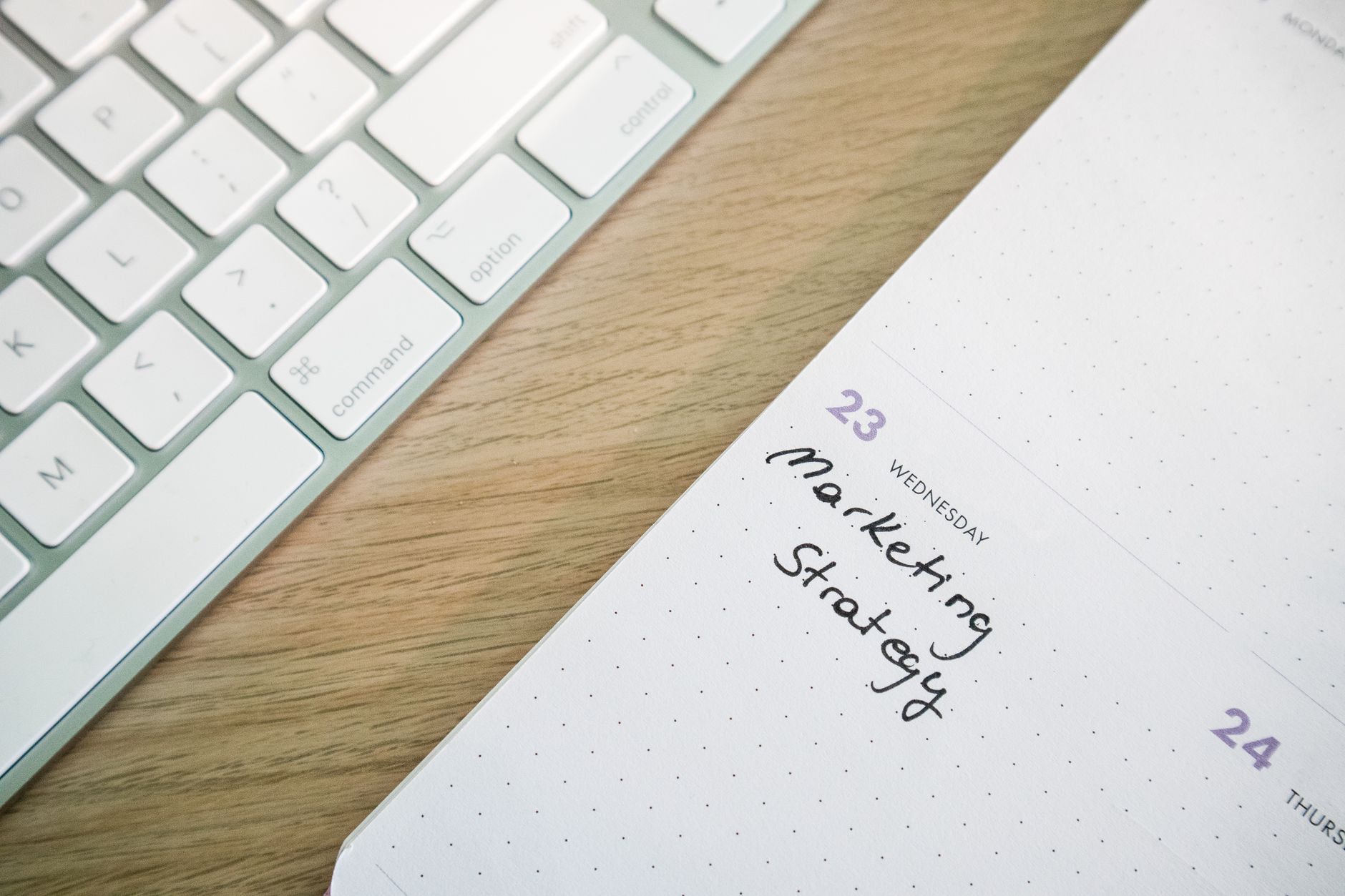 Open notebook beside a laptop used for content planning and strategy