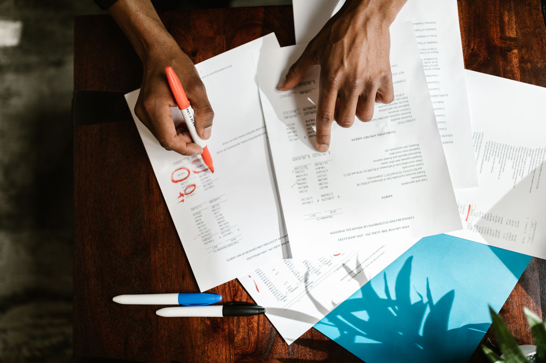 Professional reviewing software stack costs and tool subscriptions at a desk
