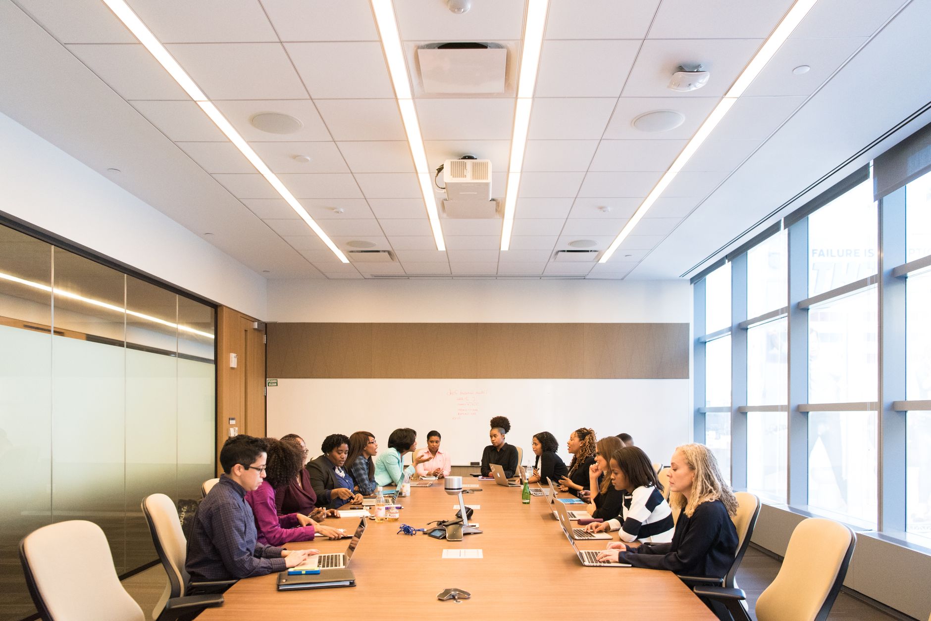 A small marketing team reviewing automation tools on laptops in a meeting