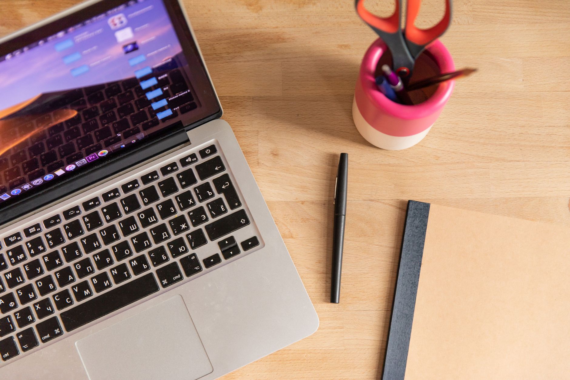 Professional at a clean workspace drafting written content