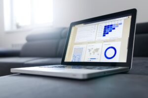 A professional reviewing LinkedIn analytics data on a laptop screen