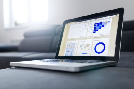 A professional reviewing LinkedIn analytics data on a laptop screen