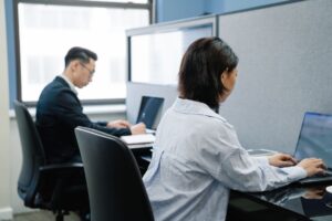 A clean modern workspace with a laptop open to a project management tool