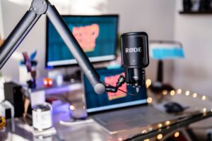 Close-up of a condenser microphone on a desk in a home recording setup