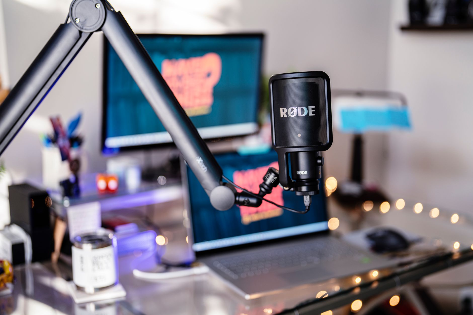 Close-up of a condenser microphone on a desk in a home recording setup