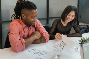 Marketing team reviewing a campaign plan on a laptop at a shared workspace