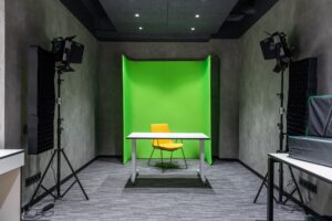 A marketing professional working at a desk with video editing software open on screen
