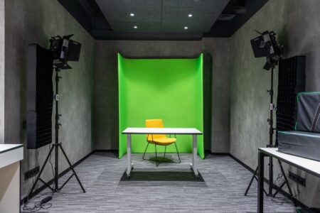 A marketing professional working at a desk with video editing software open on screen