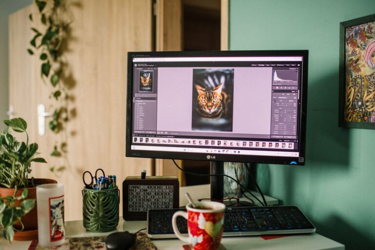 A marketer editing a product image on a laptop with design software open