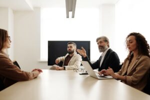 Enterprise team reviewing social media management software on multiple screens in a modern office setting