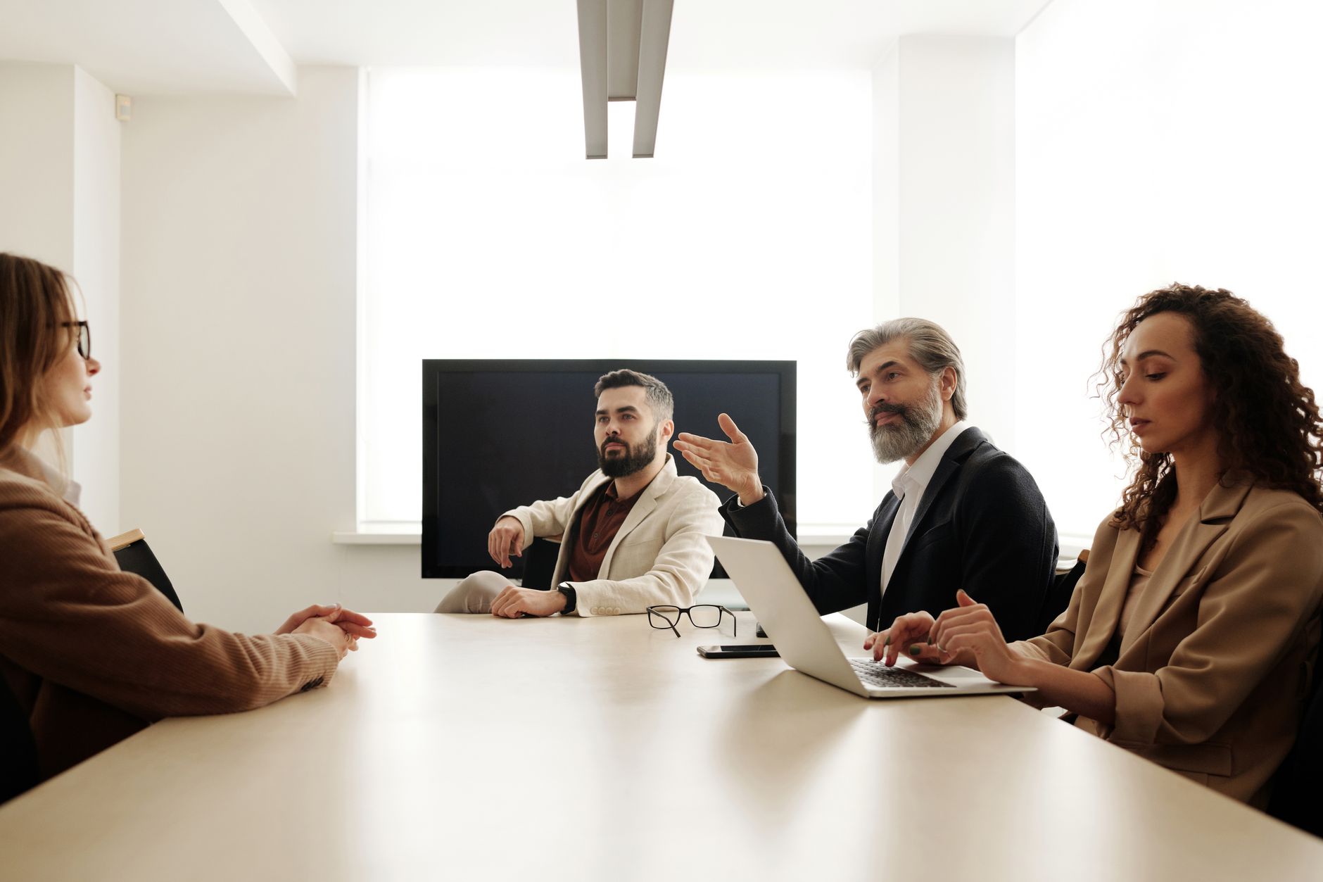 Enterprise team reviewing social media management software on multiple screens in a modern office setting