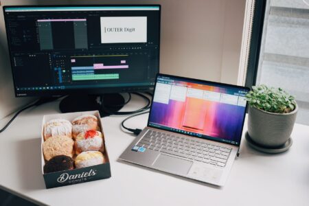A content creator editing video clips at a desktop workstation