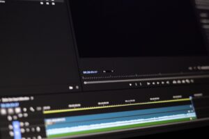 Person presenting a video pitch on a laptop screen in a modern office setting