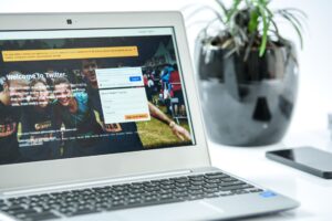 Person working on a laptop with social media content open on screen