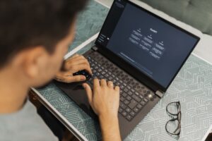 Marketer working on a laptop with an AI writing interface open on screen