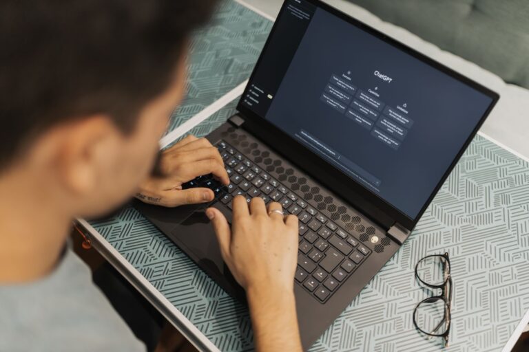Marketer working on a laptop with an AI writing interface open on screen