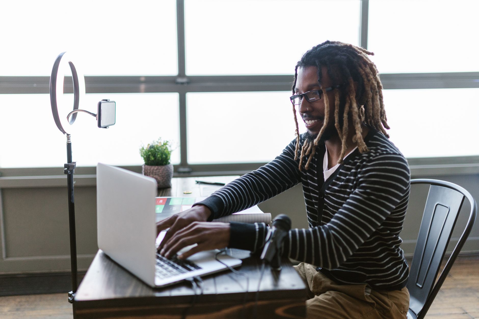 A solo content creator drafting social media posts at a desk