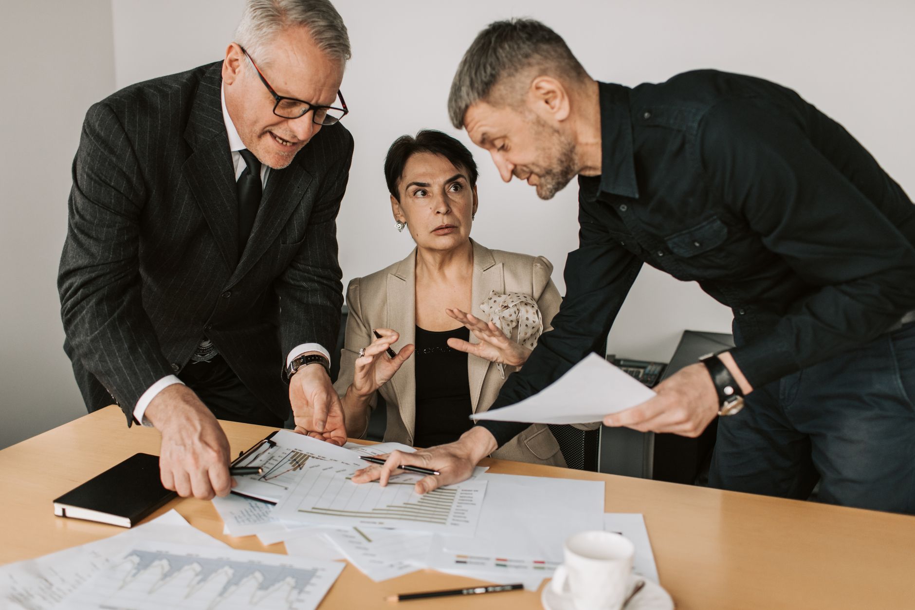 A small business team reviewing outreach strategy on laptops in a modern office