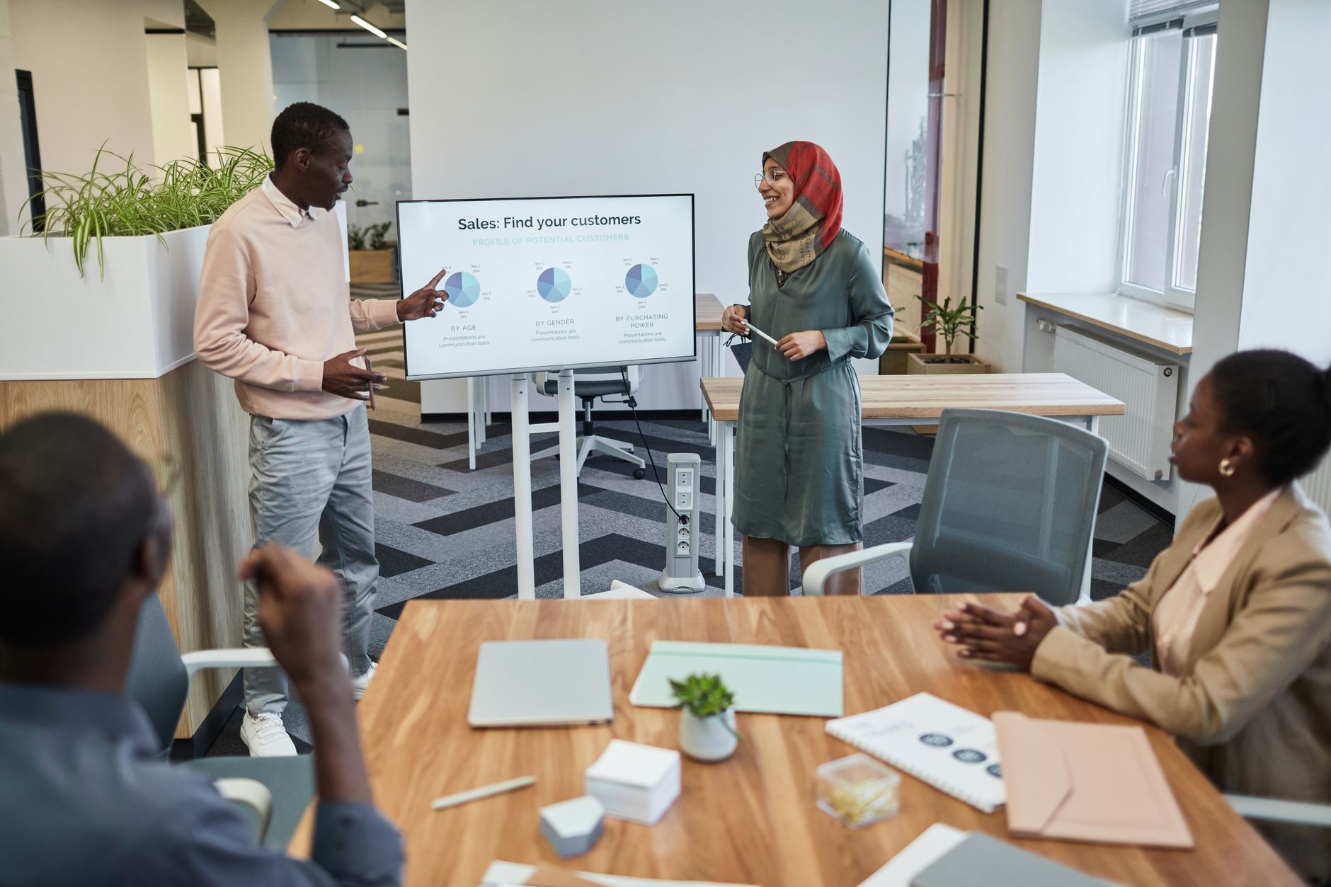 Marketing team reviewing a pitch deck during a meeting