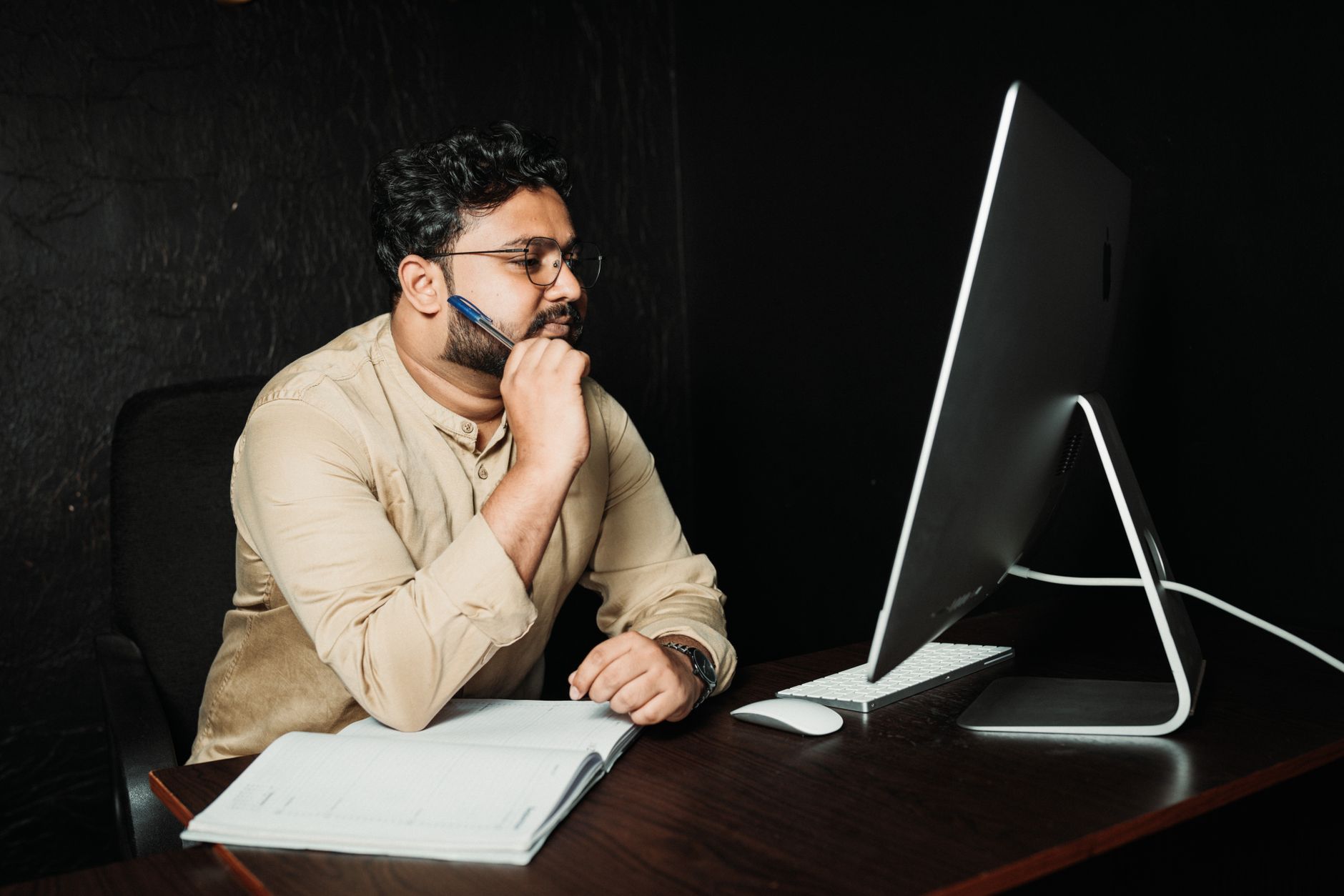 Person reviewing content on laptop screen in a modern office environment