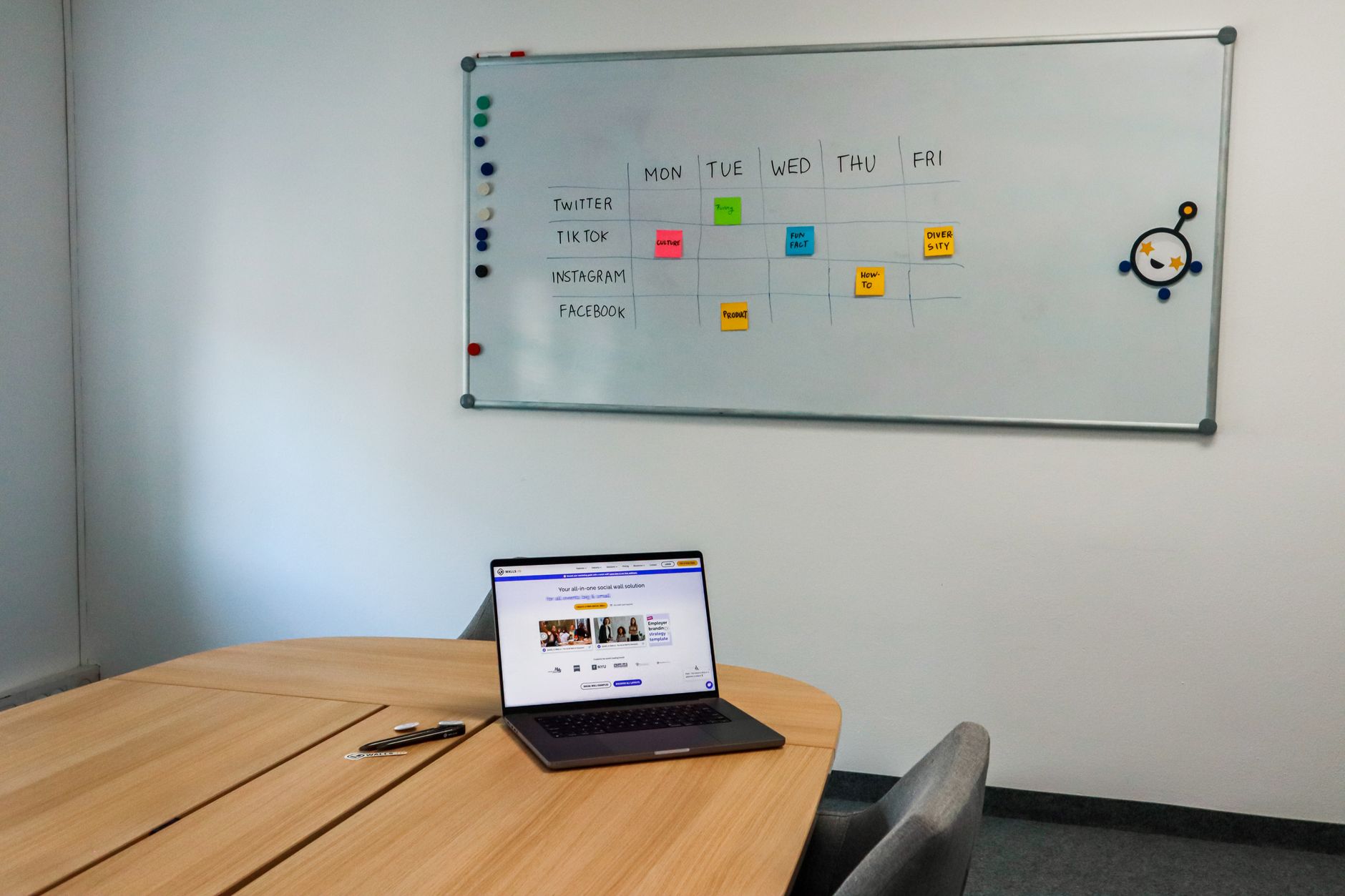 Digital calendar interface displayed on a laptop screen in a workspace