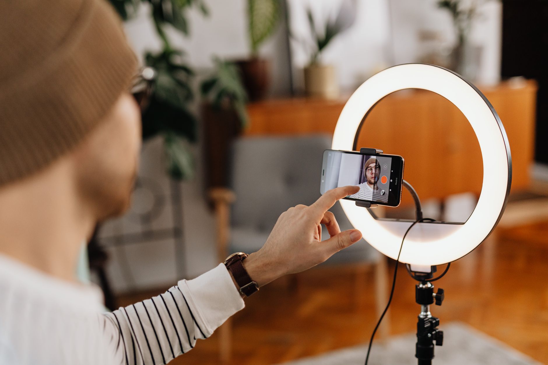 A content creator recording video in a home studio setup