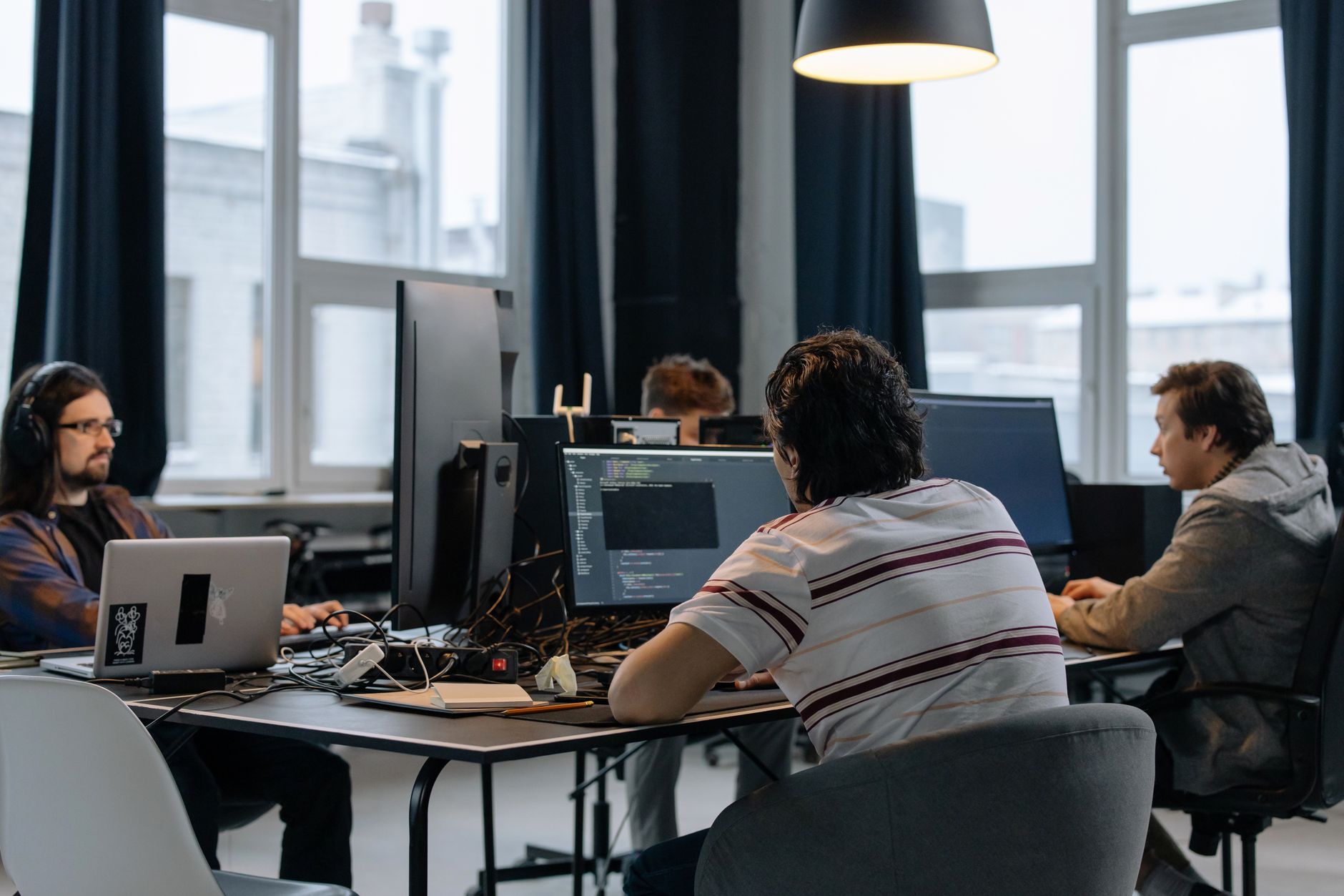 Marketing team members reviewing a shared document on a laptop screen