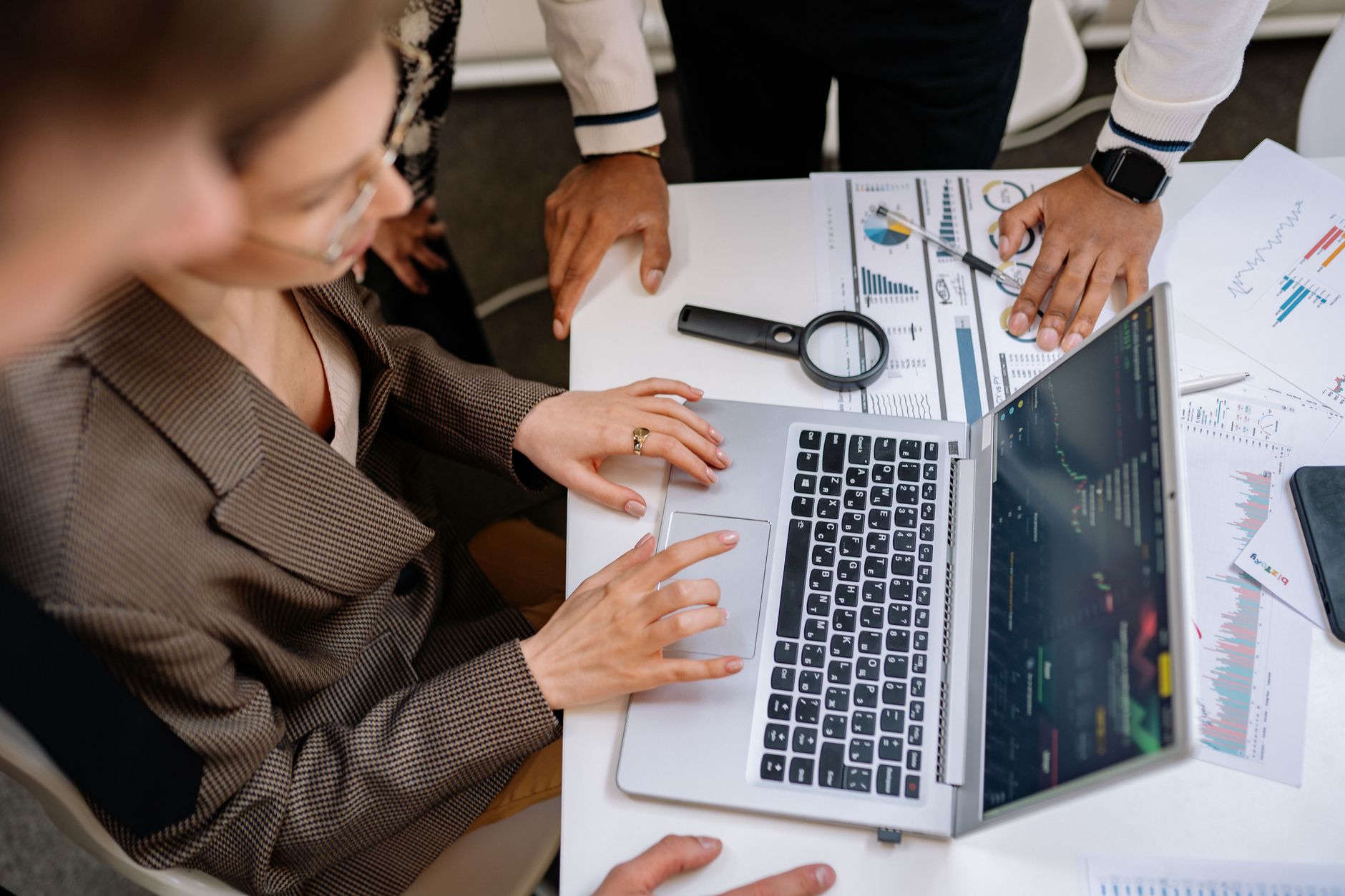A marketing team reviewing campaign performance data on laptops in an office setting