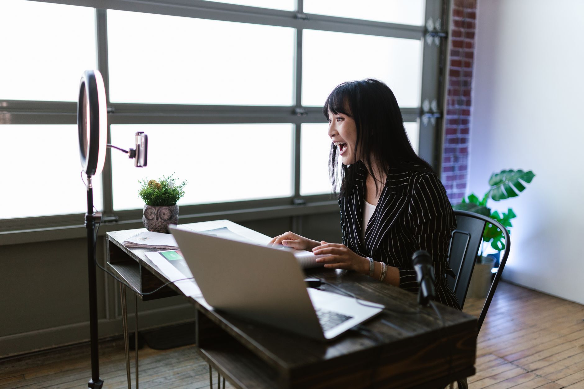 Solo content creator writing and scheduling social media posts at a desk