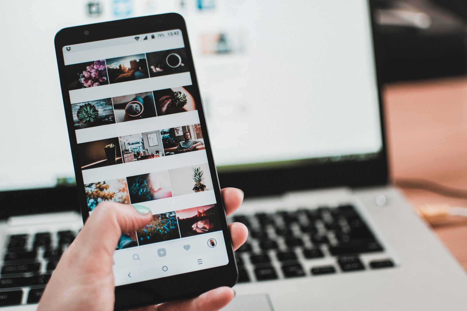 Multiple social media platform feeds displayed on a smartphone screen
